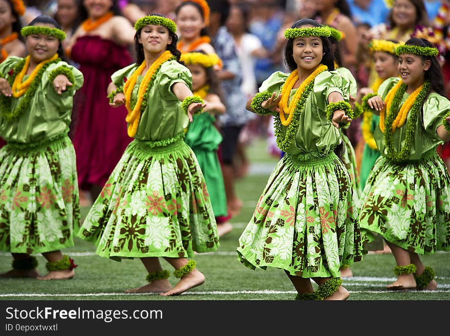 Girl&#x27;s in Green Dress Dancing during Daytime With Leis