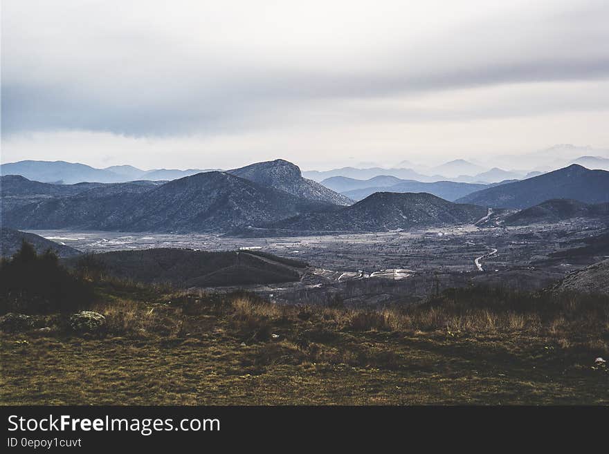 Gray Mountains and Brown and Green Weeds and Grass