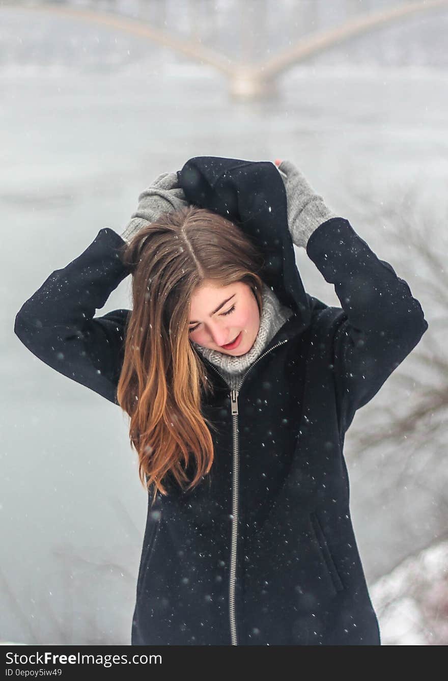 Woman Grabbing the Hood of Her Hoodie