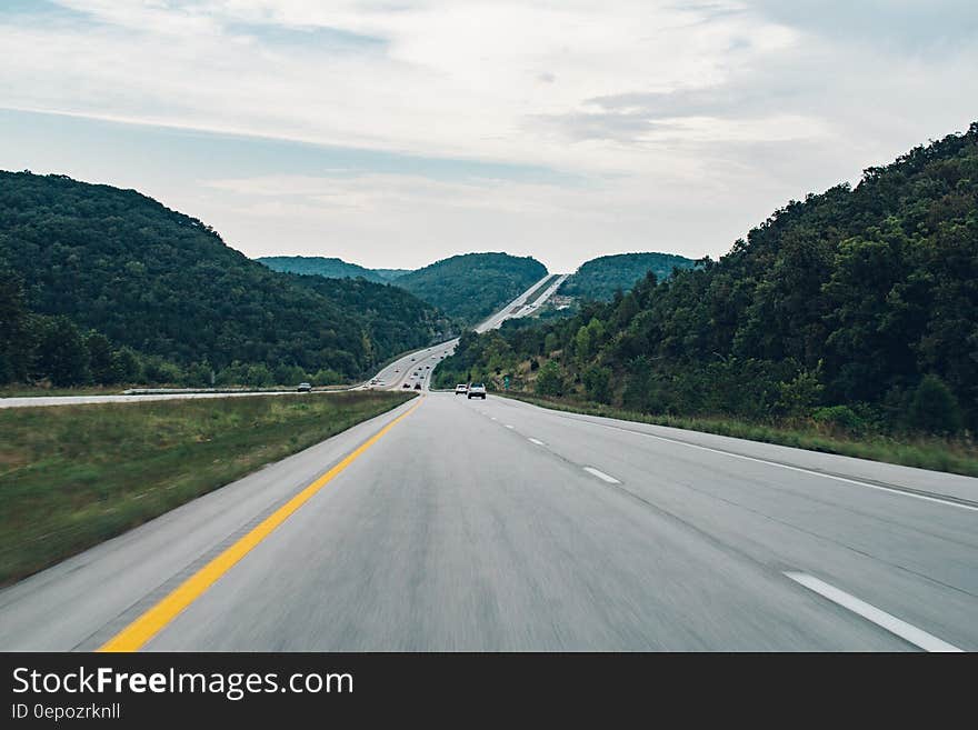 A scenic country highway on a cloudy day.