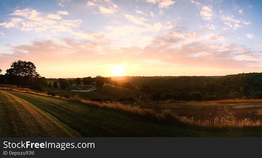 Sunset over green fields on rural hillside. Sunset over green fields on rural hillside.