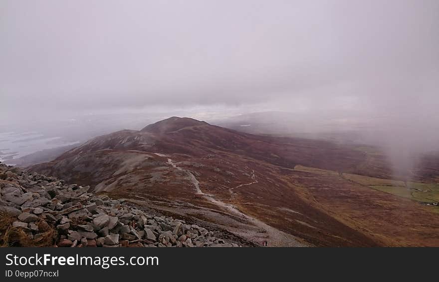 Fog over rocky crags in mountain landscape. Fog over rocky crags in mountain landscape.