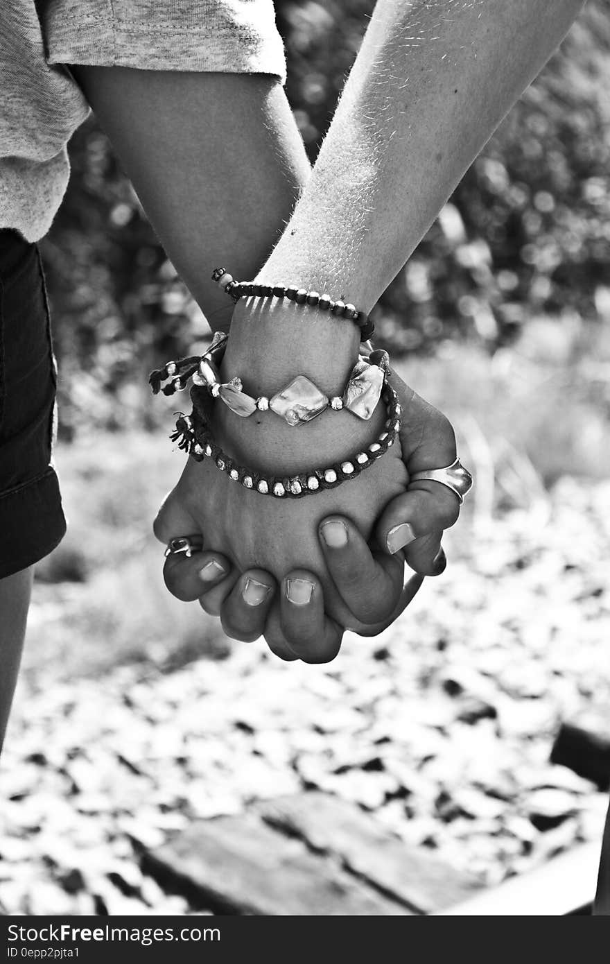 Greyscale Photography of Two Person Holding Hands