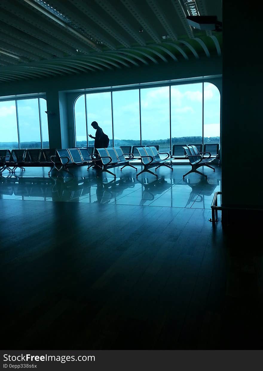 Grey Waiting Chairs and a Man