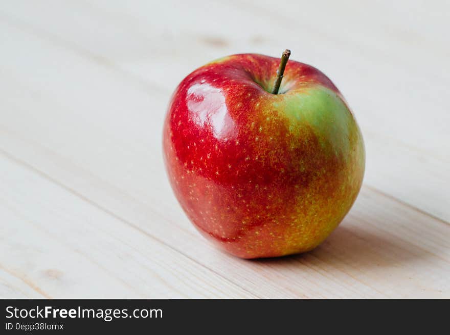 Close up of red and green apple on painted wooden planks. Close up of red and green apple on painted wooden planks.