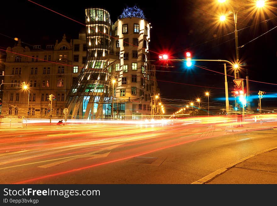 City streets with blur of traffic lights through intersection. City streets with blur of traffic lights through intersection.