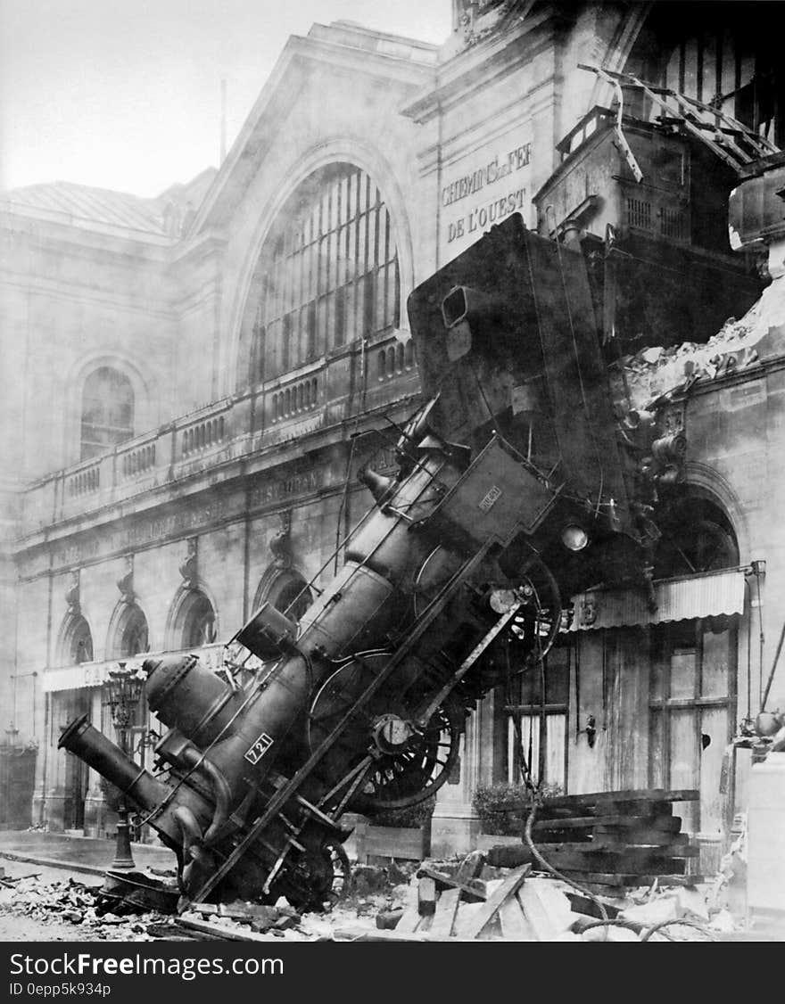 Locomotive engine through walls of train station in Montparnasse, Paris, France in 1895 in black and white. Locomotive engine through walls of train station in Montparnasse, Paris, France in 1895 in black and white.