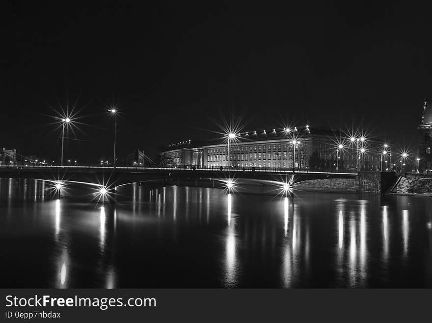 White Building Near Bridge With Lights