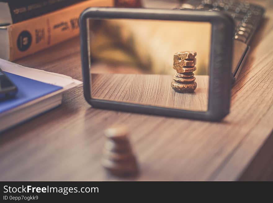 Black Frame Mirror on the Brown Wooden Table