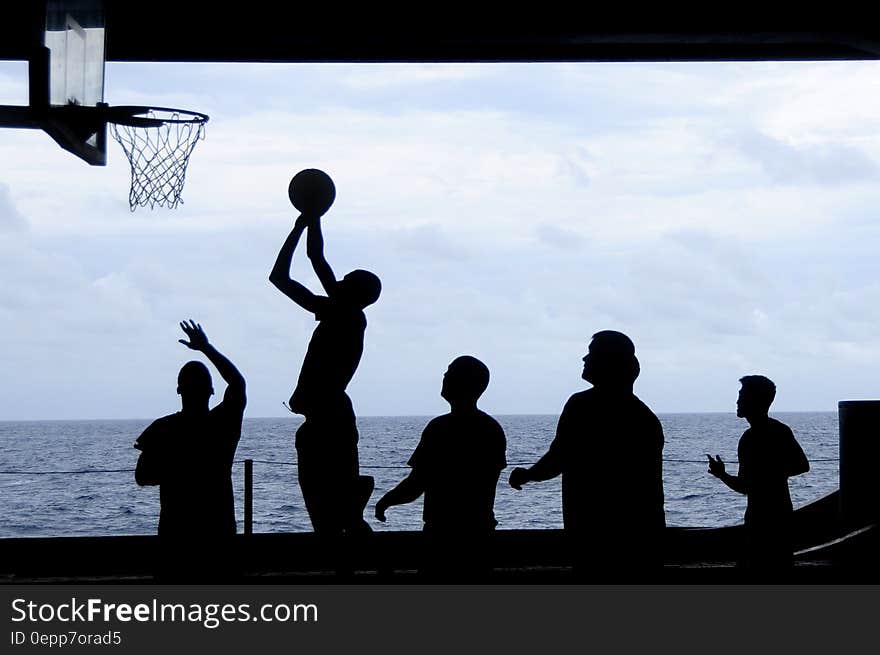 Silhouette of Men Playing Basketball