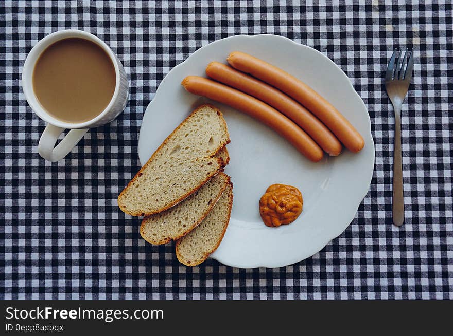 Sausages, Bread and Coffee on Table