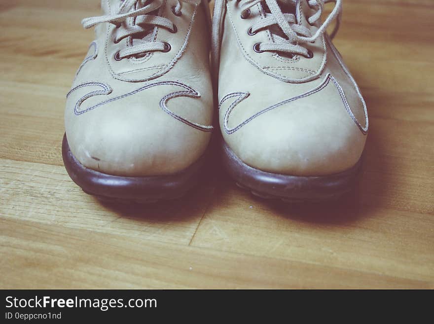 Close up of leather shoes on wooden floor.