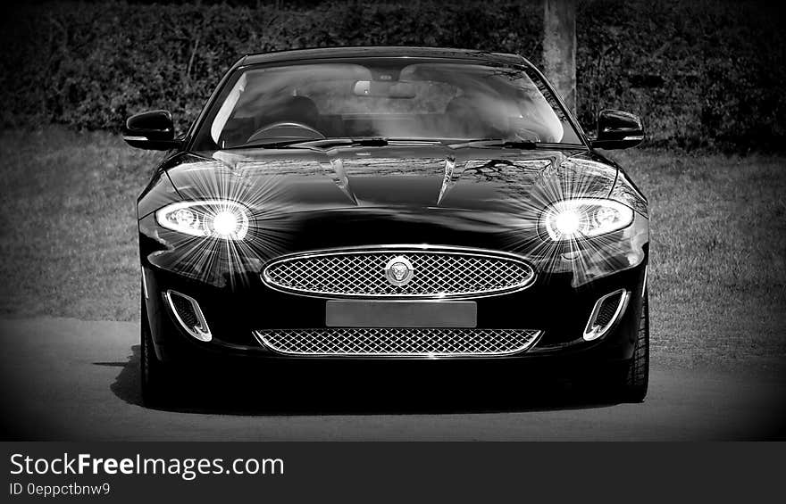 Grayscale Photo of a Black Sports Car Convertible