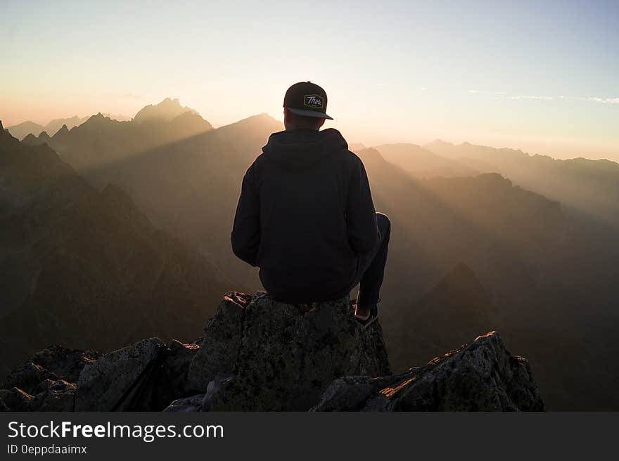 Man Sitting on the Mountain Edge