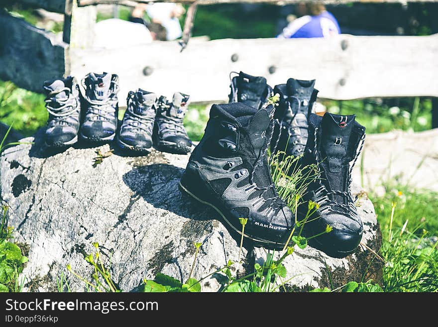 Black and Grey Hiking Shoes on Grey Rock during Daytime