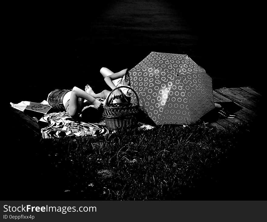 People Laying on Blanket Grayscale Photo