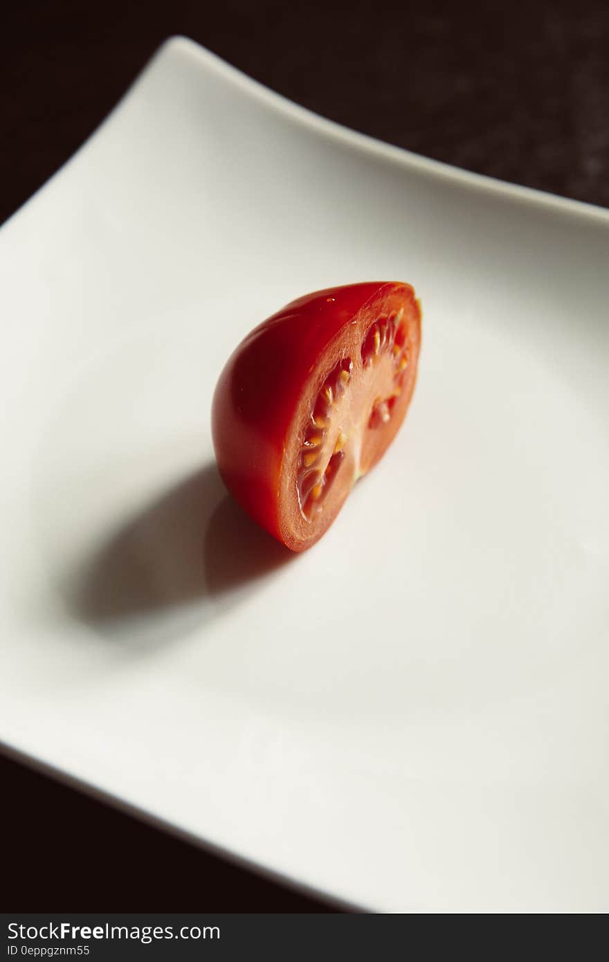 Red Tomato on White Ceramic Plate