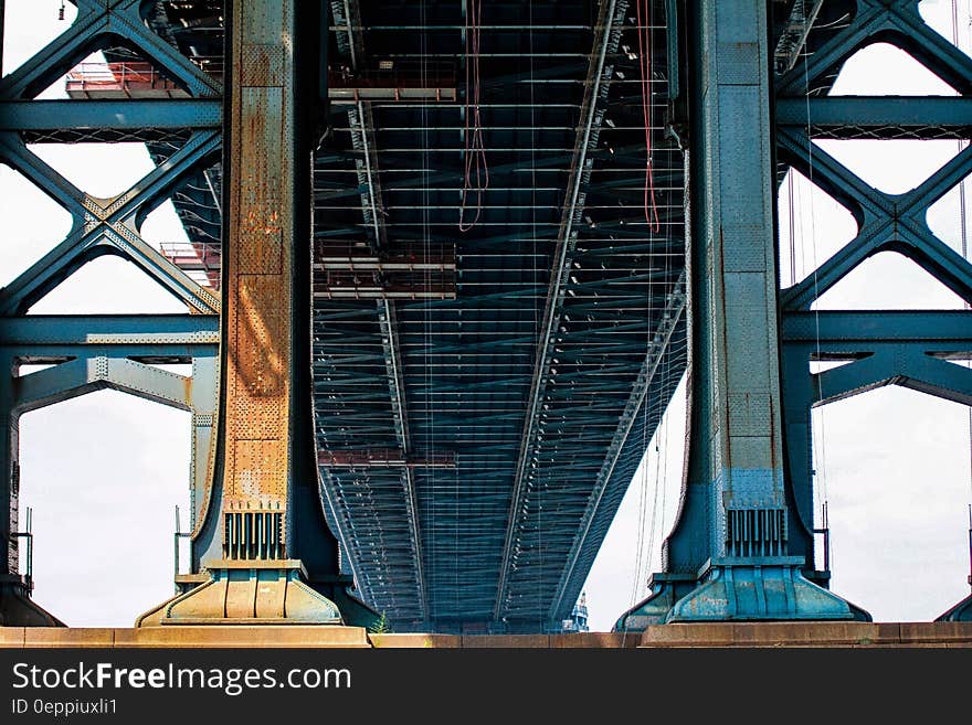 Blue Metal Bridge in Low Angle Photo at Daytime