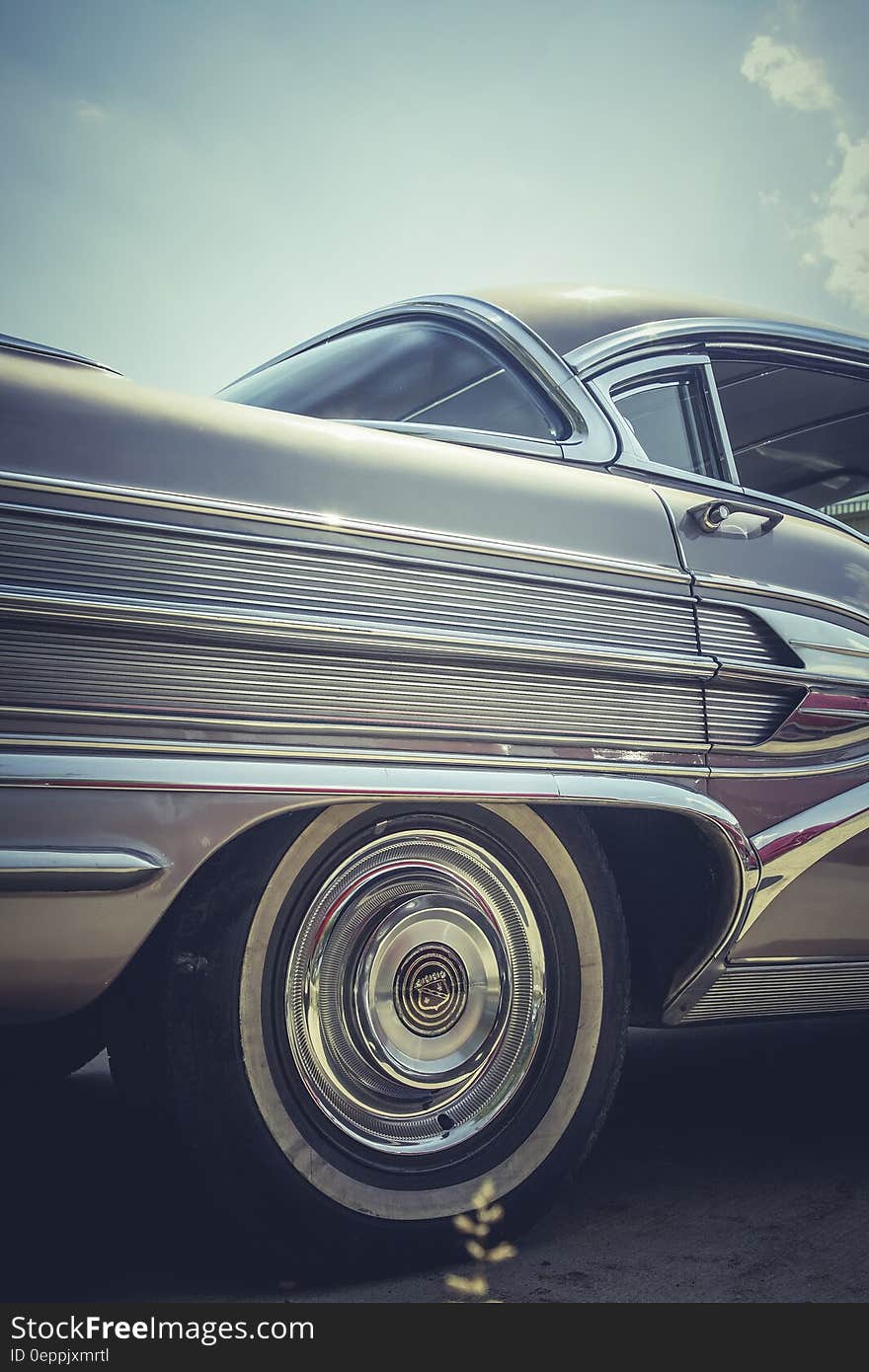 A close up of the rear wheel of a classic car.