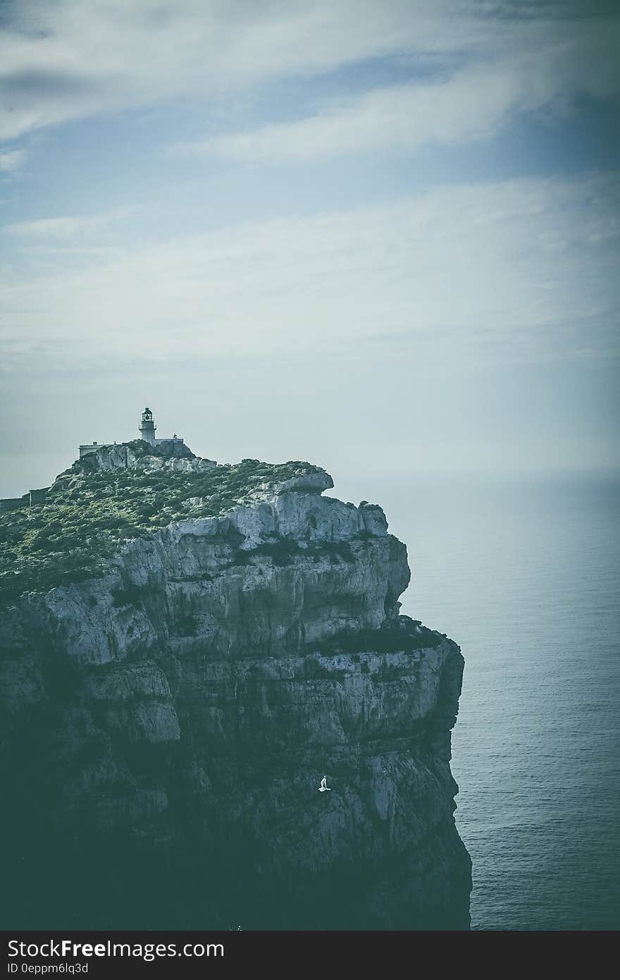 Scenic view of lighthouse on rocky cliffs of Capo Caccia, Alghero, Sassari, Italy. Scenic view of lighthouse on rocky cliffs of Capo Caccia, Alghero, Sassari, Italy.