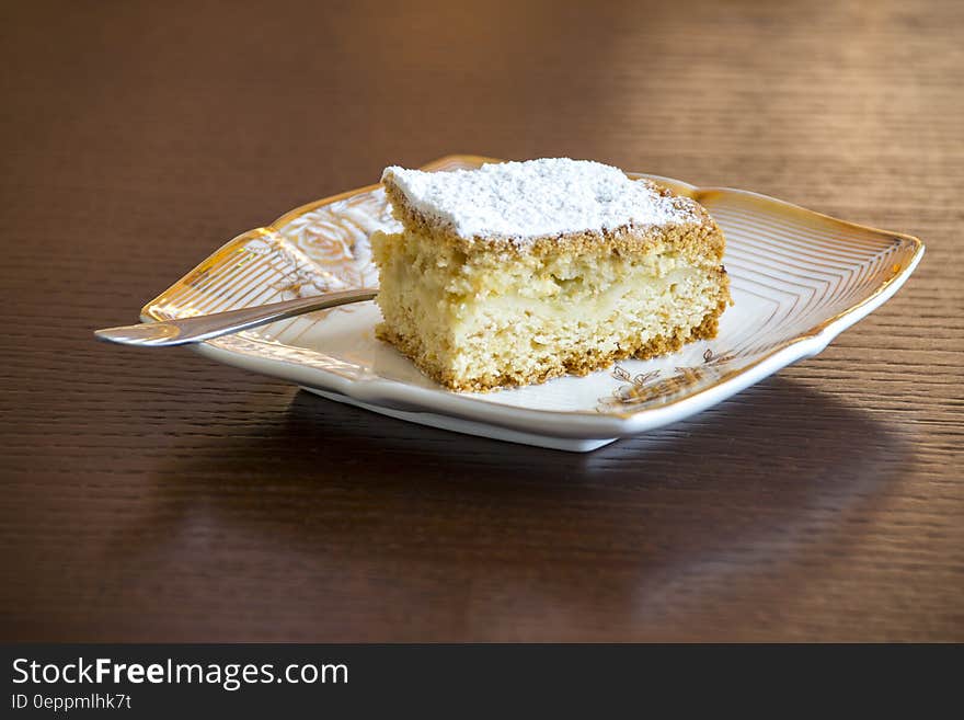 Brown and White Sliced Cake on White and Brown Ceramic Plate