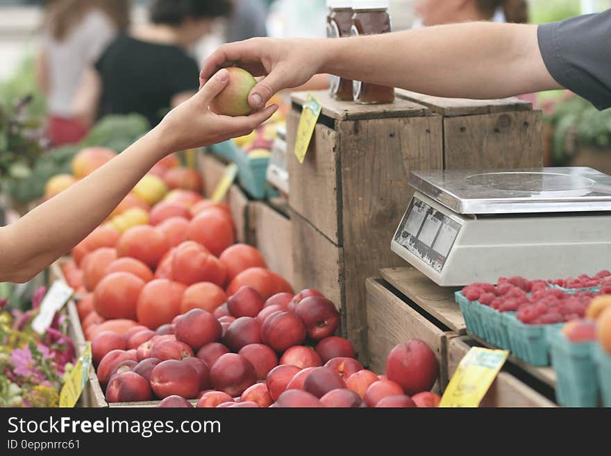 Person Giving Fruit to Another