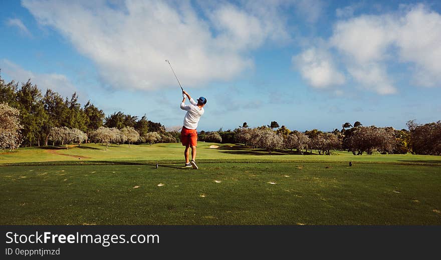 Man in White T Shirt Playing Golf