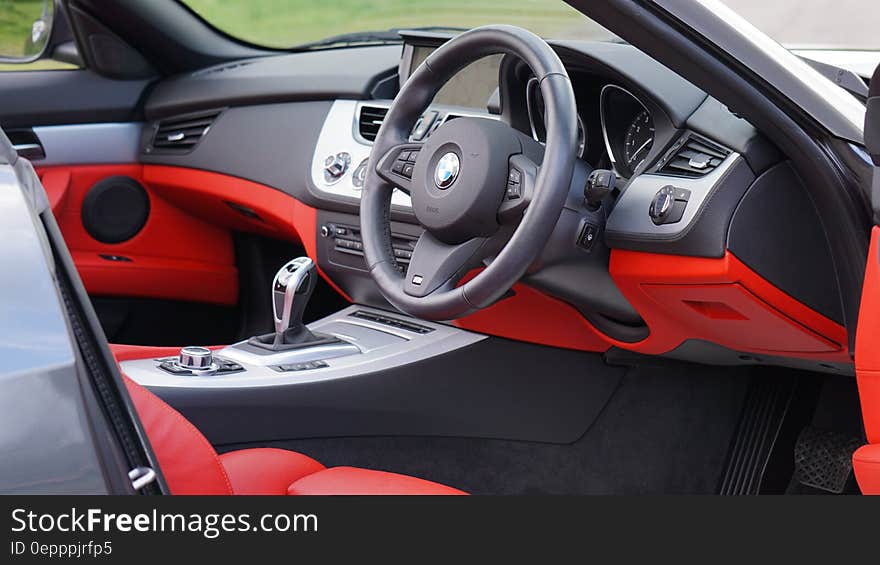 Black and red leather interior of BMW Z4 sports car outdoors on sunny day. Black and red leather interior of BMW Z4 sports car outdoors on sunny day.