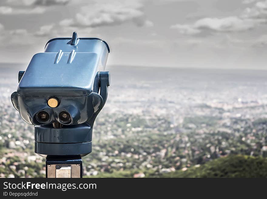 Blue Coin Operated Binocular With City View during Daytime