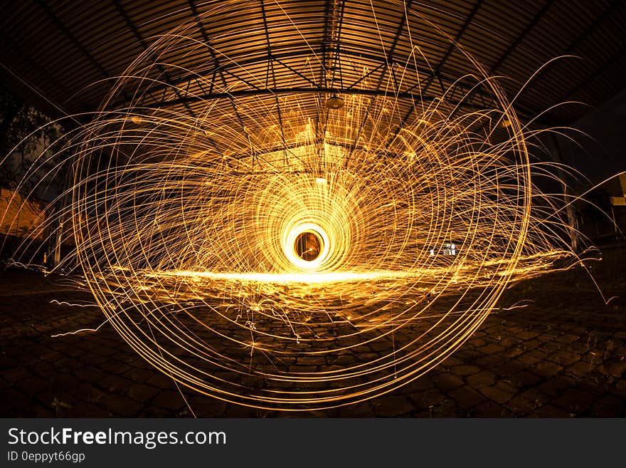 A long exposure of sparks flying from a spinning disk.