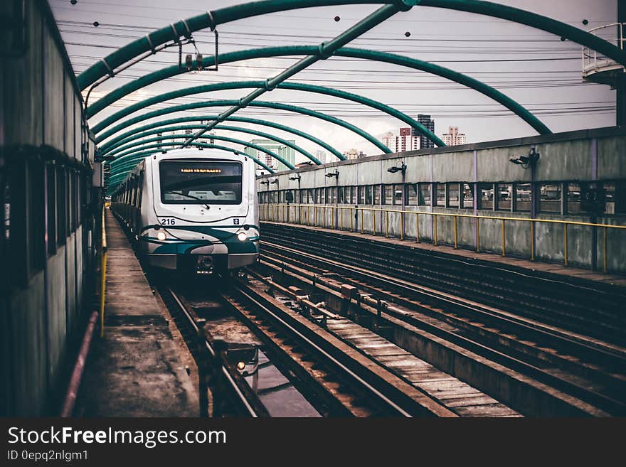 Gray and Green Train on Railings during Daytime