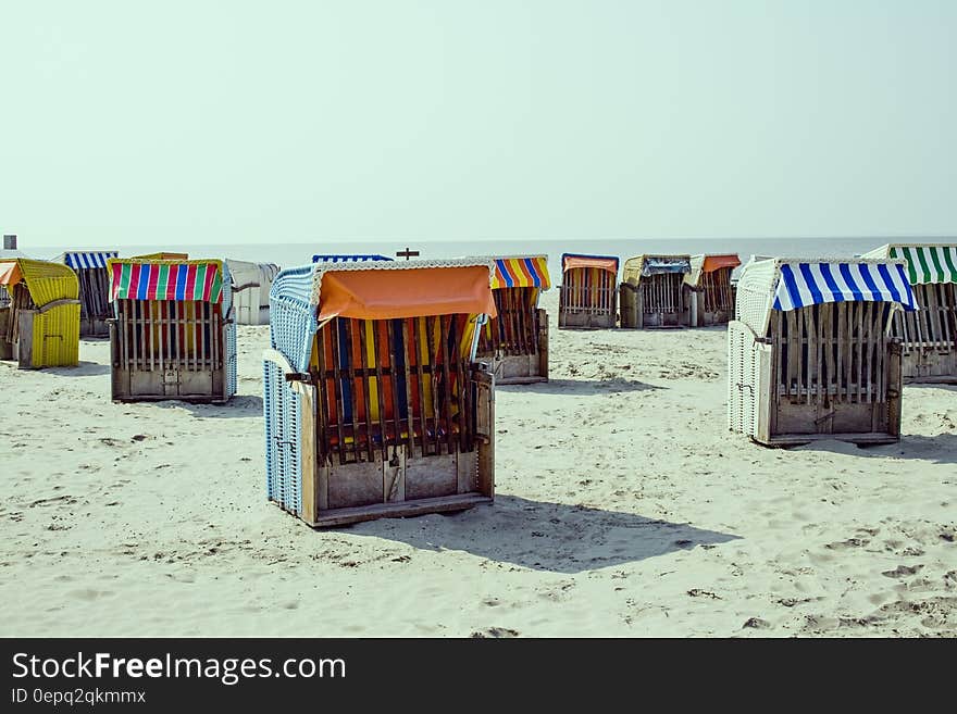 Strandkorb, little hooded beach chairs on the sandy beach in summer. Strandkorb, little hooded beach chairs on the sandy beach in summer.