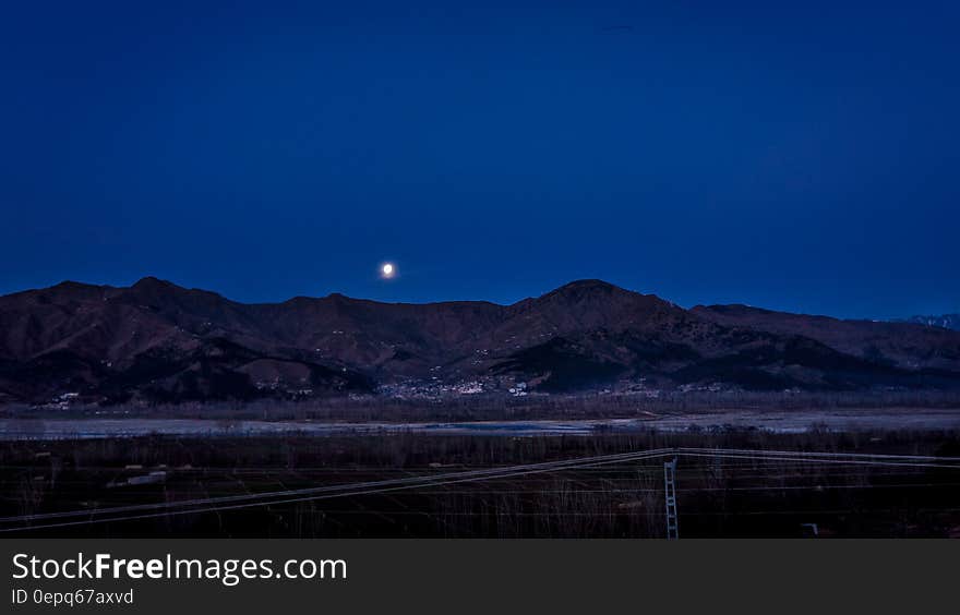 Full Moon Above the Mountain Ranges Near Town