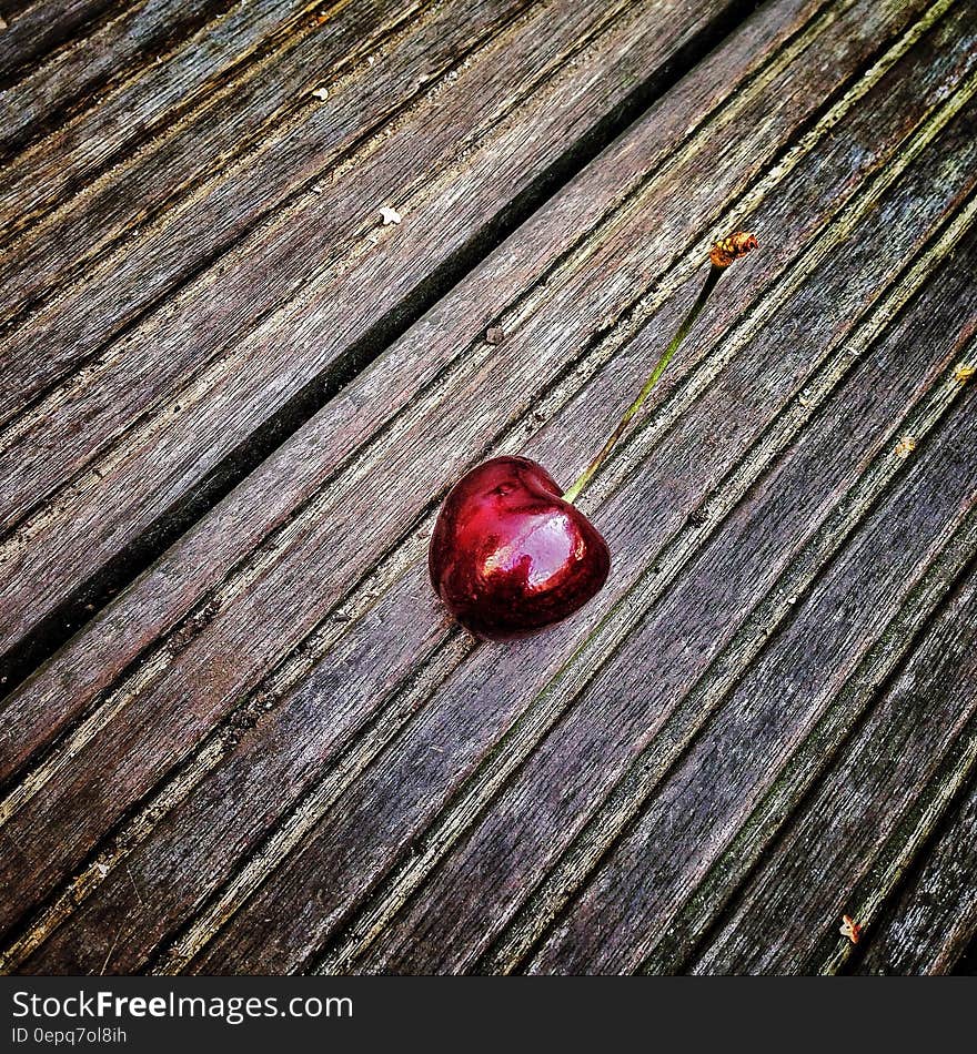 Red Cherry on Wooden Surface