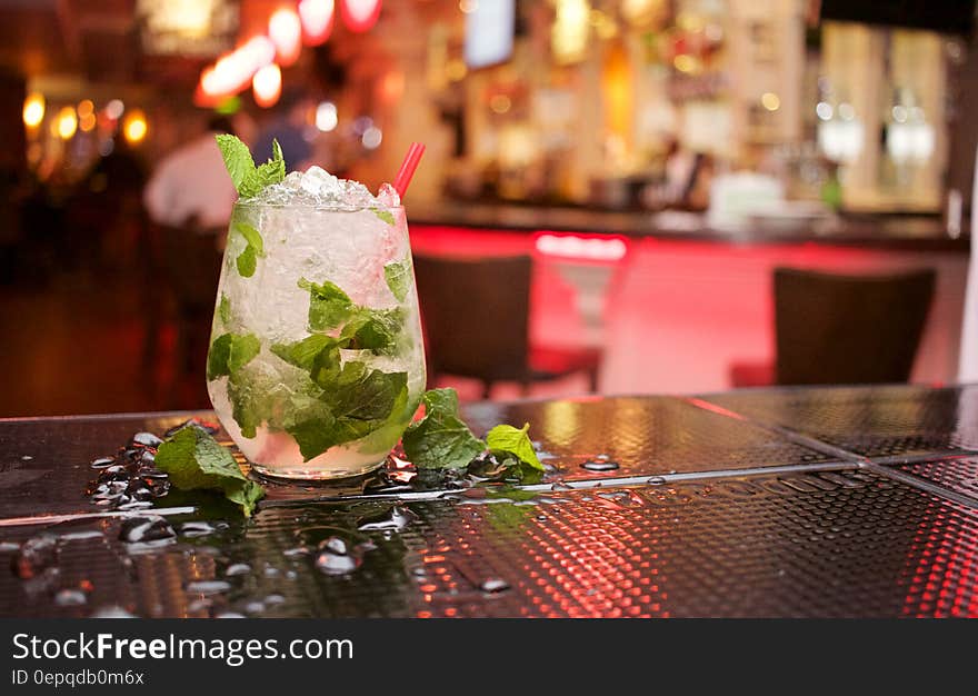 Close up of mojito cocktail with fresh mint on bar counter. Close up of mojito cocktail with fresh mint on bar counter.