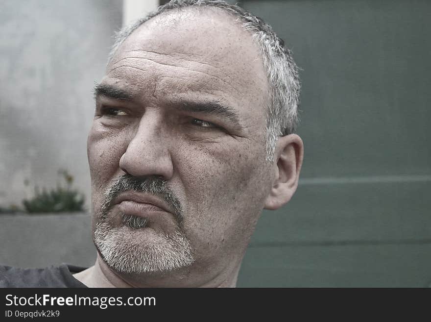 Man in Black Shirt Near Gray Wall