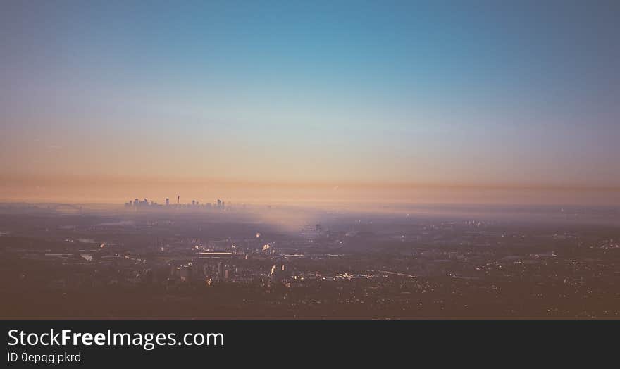 Skyline of Sydney, Australia on horizon through fog at sunset. Skyline of Sydney, Australia on horizon through fog at sunset.