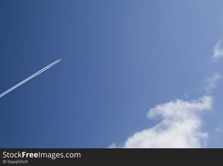 Jet Under Clear Blue Sky during Daytime