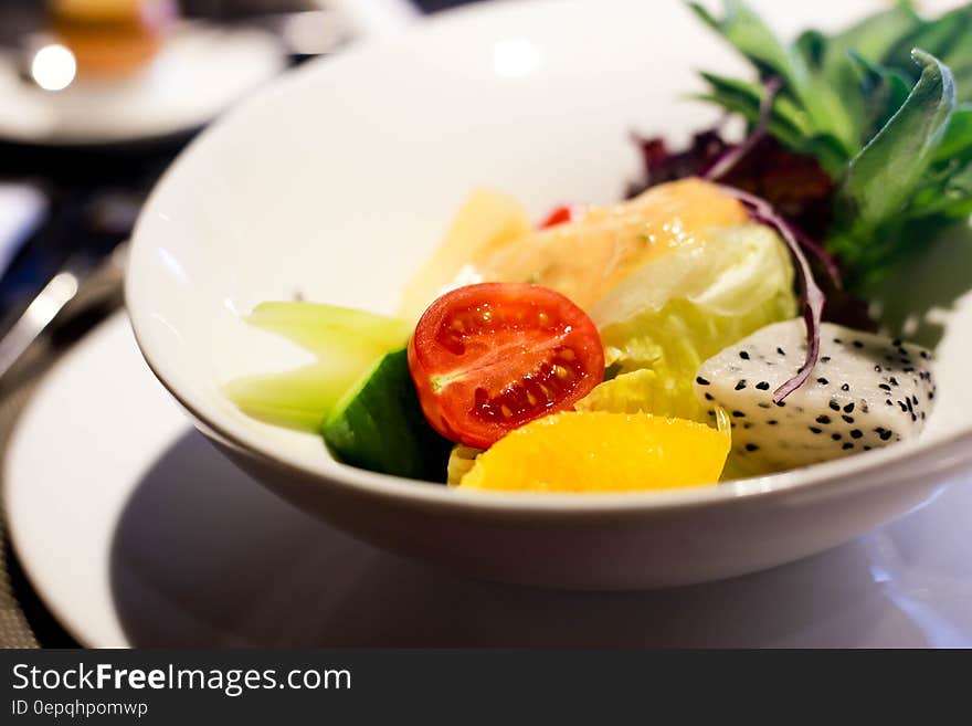 Sliced Tomatoes and Fruits on White Round Bowl