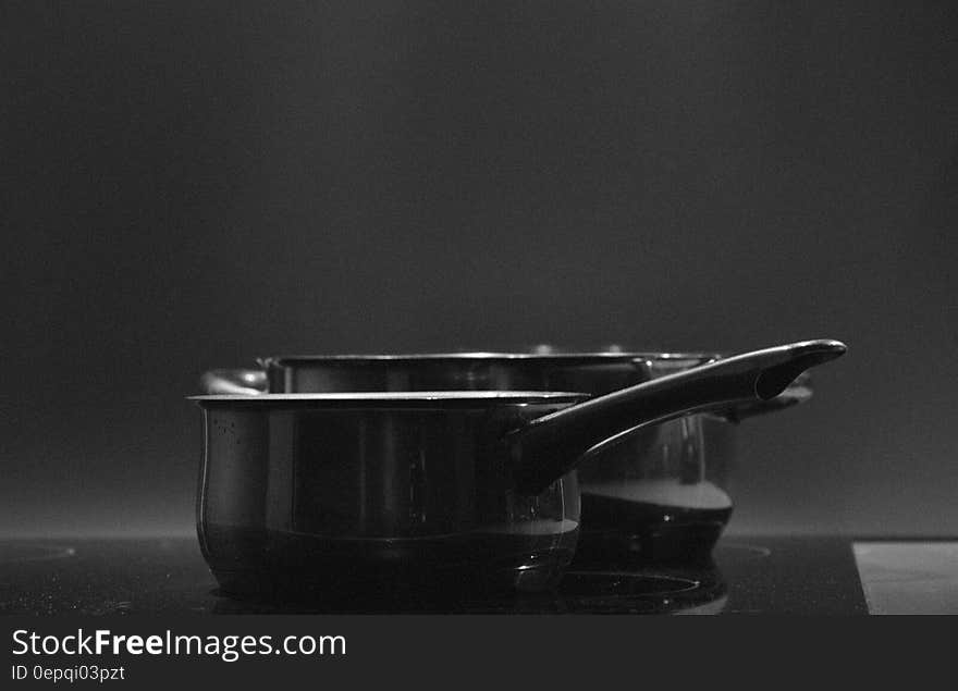 Close up of pots on electric stove in black and white. Close up of pots on electric stove in black and white.