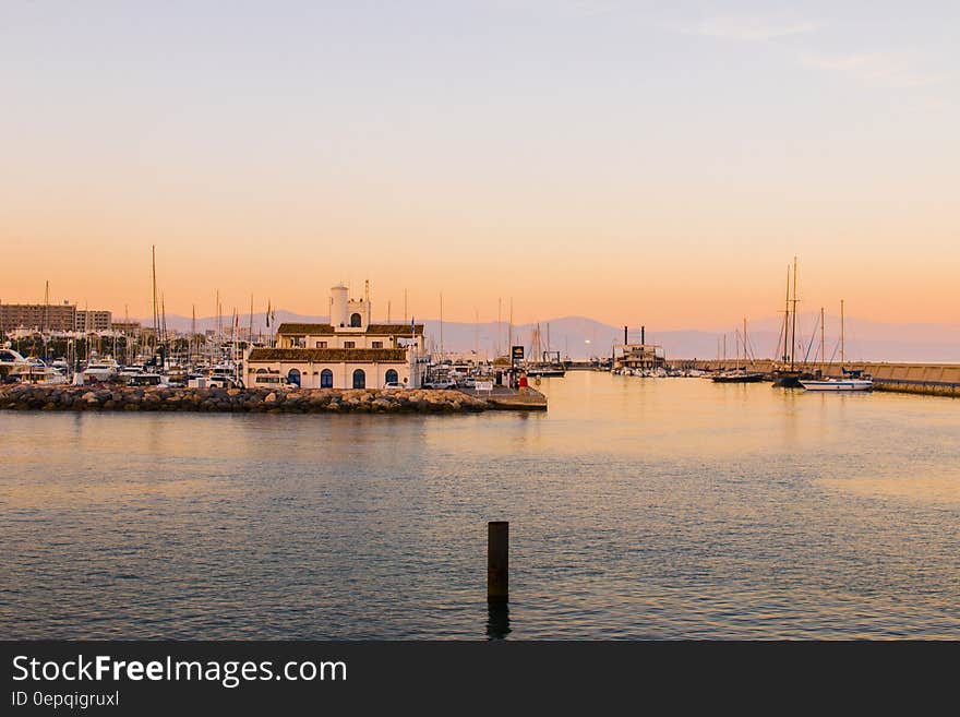 Boats anchored in marina at sunset. Boats anchored in marina at sunset.