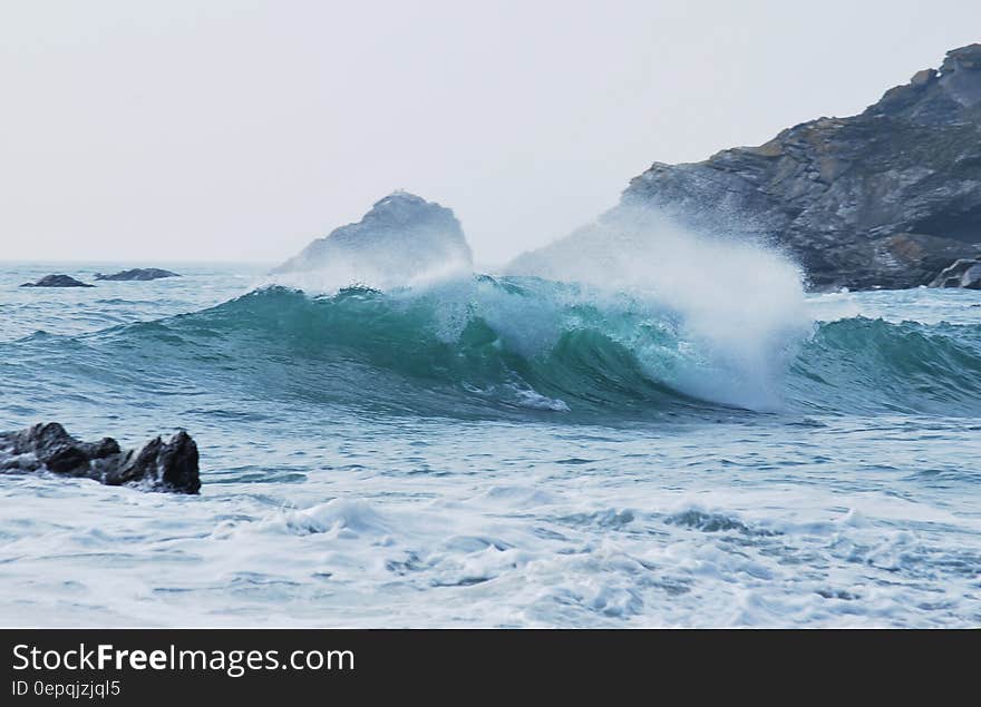 Splashy sea waves and rocky coast in the background.