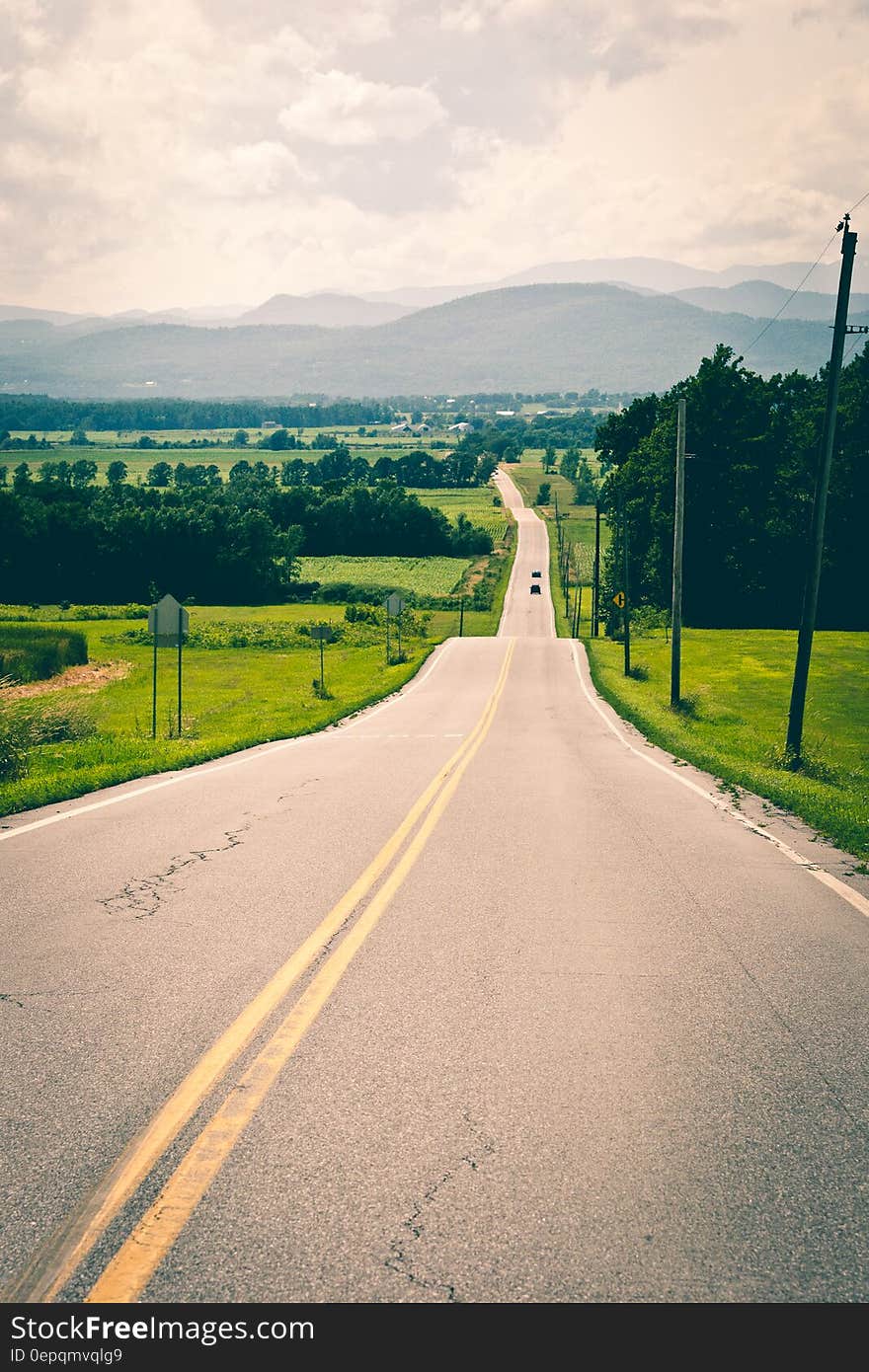 A view of a highway passing through green fields. A view of a highway passing through green fields.