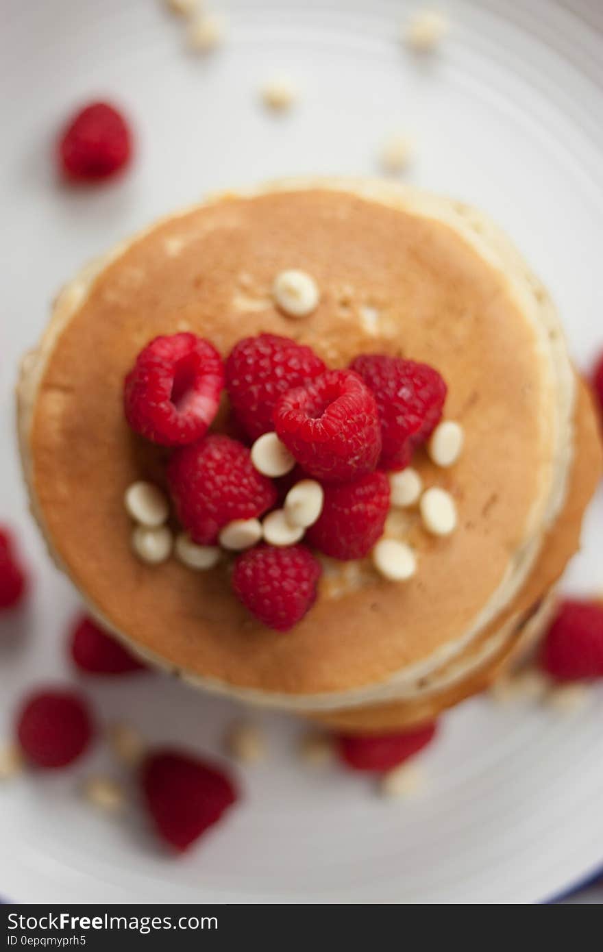 Pancakes and fresh raspberries on white china plate. Pancakes and fresh raspberries on white china plate.