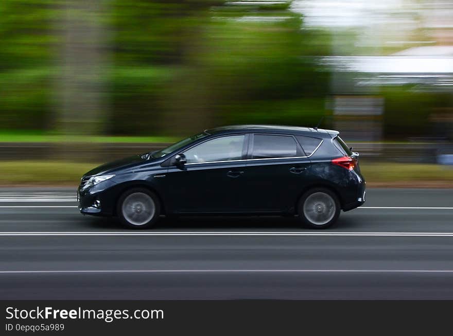 Car driving on sunny road with blur of landscape in daytime. Car driving on sunny road with blur of landscape in daytime.