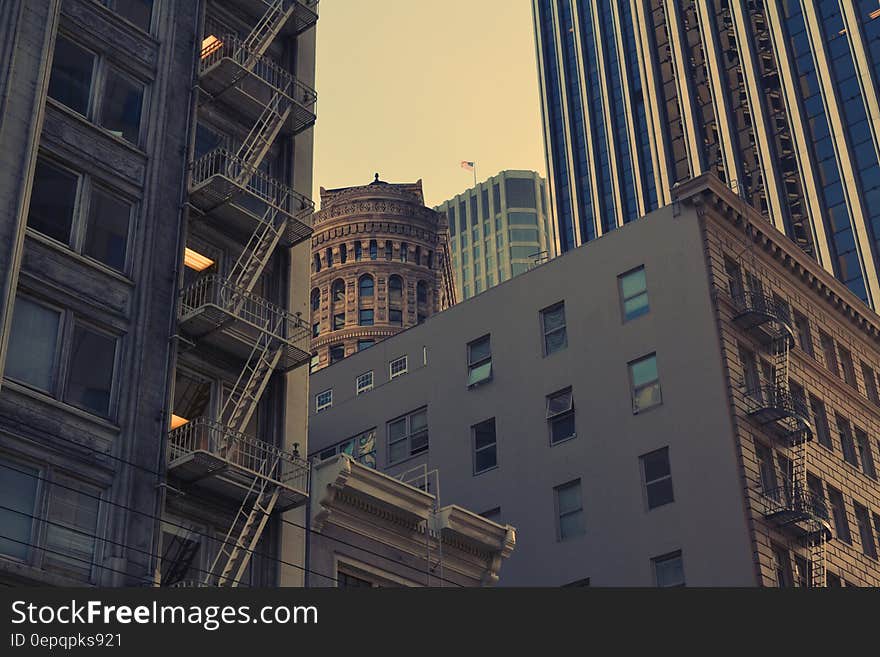 A view of a city with both old and modern buildings next to one another. A view of a city with both old and modern buildings next to one another.