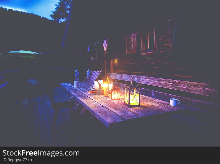 Black Lantern on Brown Wooden Table Under Blue Sky