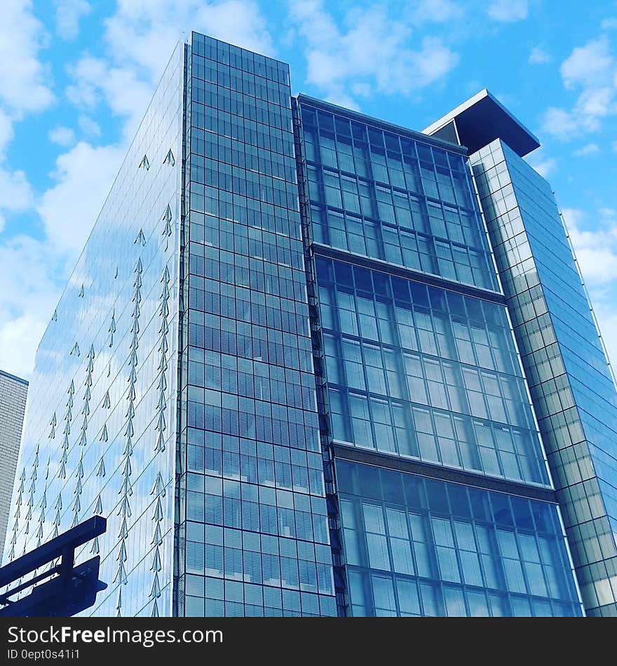 Low Angle View of Glass High Rise Building during Cloudy Daytime Photo