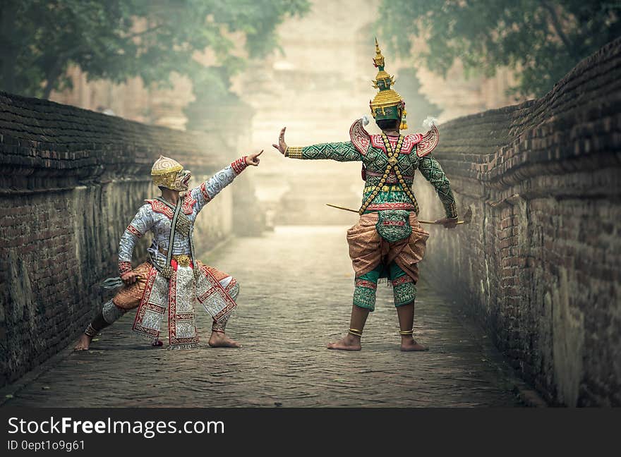 Asian actors dressed as ancient warriors on stone bridge on sunny day. Asian actors dressed as ancient warriors on stone bridge on sunny day.