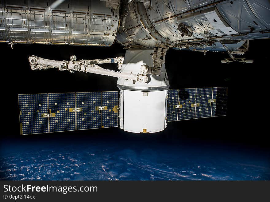 Panels on satellite orbiting earth.